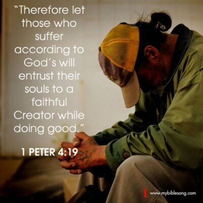 Therefore let those who suffer according to God’s will entrust their souls to a faithful Creator while doing good. 1 Peter 4:19 A person praying with hands clasped, wearing a green jacket and a baseball cap, reflecting faith and prayer.