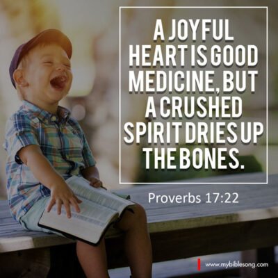 A joyful heart is good medicine, but a crushed spirit dries up the bones. Proverbs 17:22 Joyful child reading Bible, smiling and laughing, emphasizing happiness in faith and spirituality.