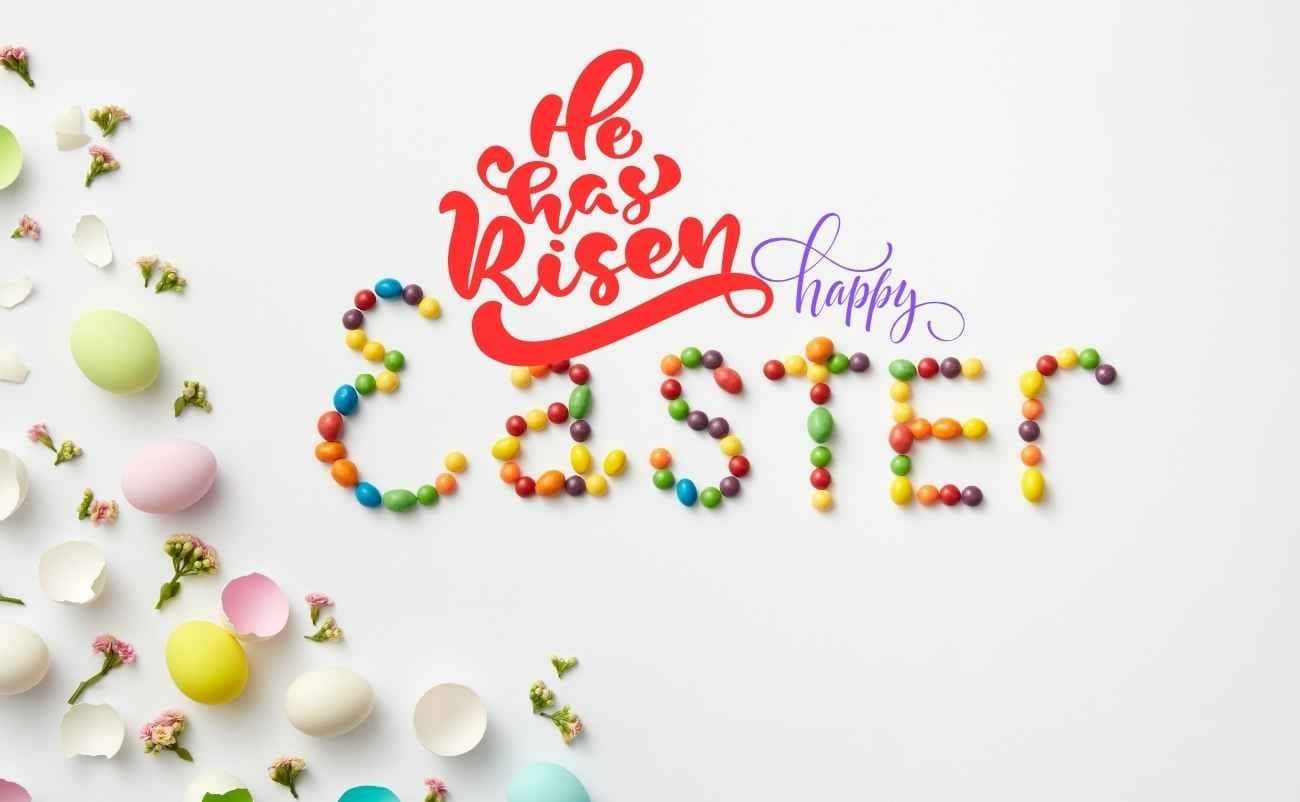 Celebrate a Joyful Easter : Happy Easter Wishes Images and Quotes with Bible Verses My Bible Song 2026 He has risen happy Easter eggs and colorful candies arranged on a white background for celebrating the resurrection of Jesus Christ.