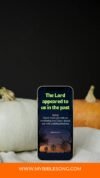Bible verse on smartphone screen with autumn scenery; Christian prayer, faith, and spiritual songs; religious apps; hope and encouragement; inspirational scripture.
