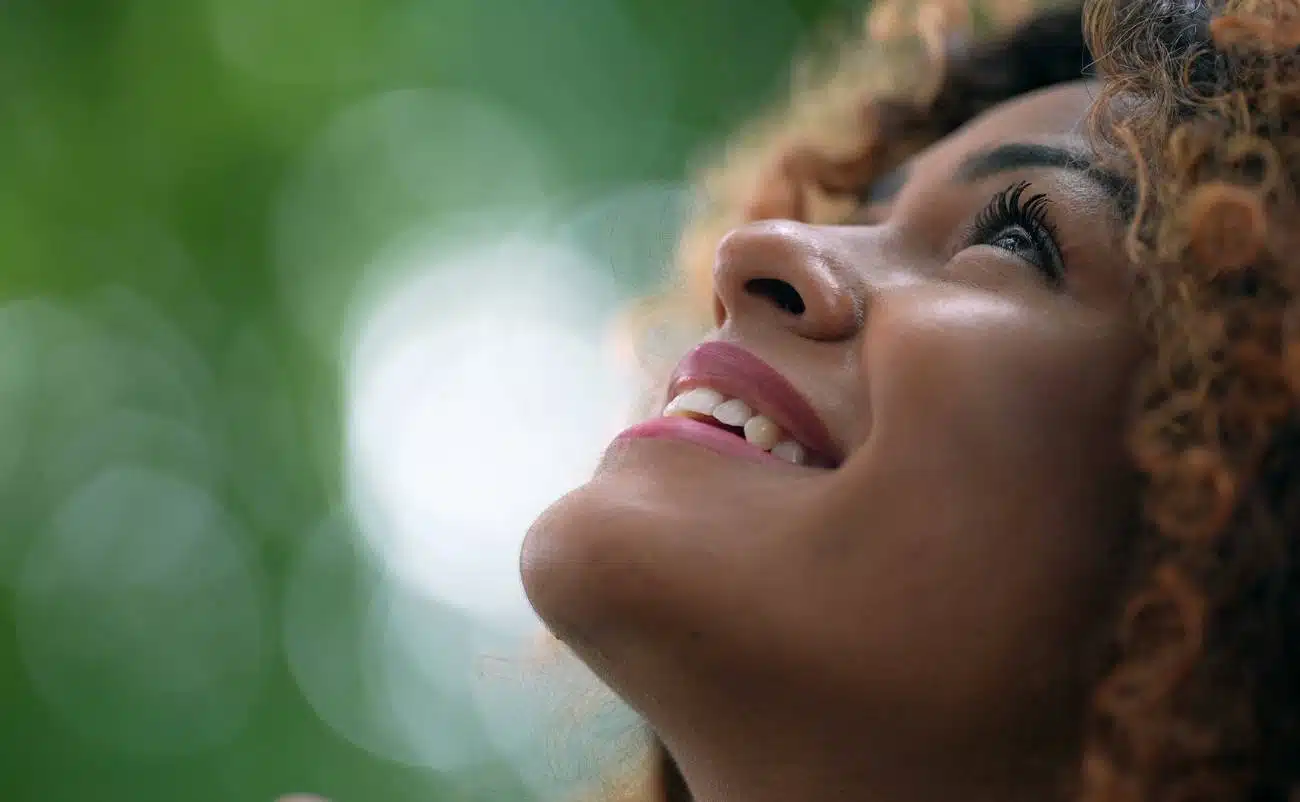 Unveiling the Shield: Encouraging Bible Verses About God's Protection My Bible Song 2026 Smiling woman enjoying worship and praise, uplifting spiritual song, joyful expression, close-up of face, nature background, outdoor praise, Christian worship music, faith and happiness, vibrant devotional spirit.