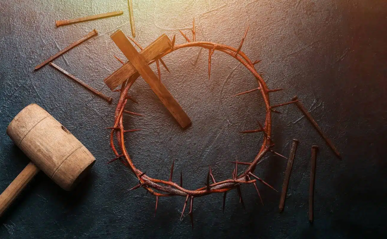 Crown of thorns with nails and a wooden cross, symbolizing Jesus' crucifixion and sacrifice in Christian faith. Perfect for biblical and spiritual themes related to salvation and redemption.