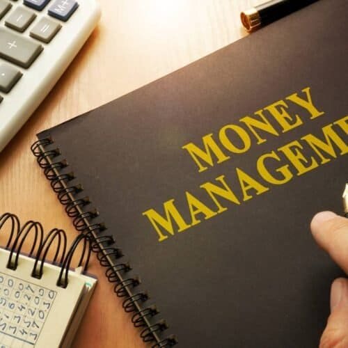 22 Scriptural Guidance for Prudent Money Management : Navigating the Financial Realm My Bible Song 2025 Computers and notebooks with the words money management on a black notebook cover, accounting and financial planning concept, financial books and tools for budgeting and savings, organized finance and banking materials, workplace finance setup.