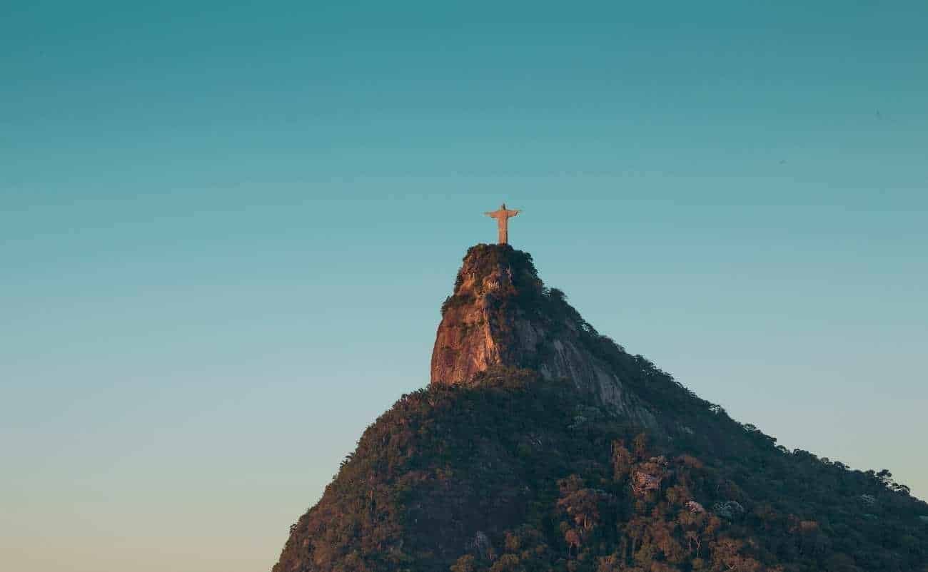 Jesus Christ on the cross at the top of Mount Corcovado in Rio de Janeiro, Brazil, symbolizing faith, salvation, and Christianity. Iconic religious monument with scenic sky background.