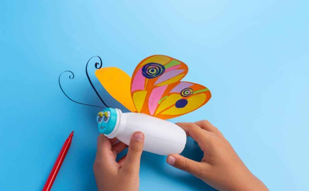 Colorful paper butterfly craft using a glue stick and red marker, creative arts activity for kids, DIY butterfly art project, vibrant craft for children, fun home or classroom activity for kids' creativity.