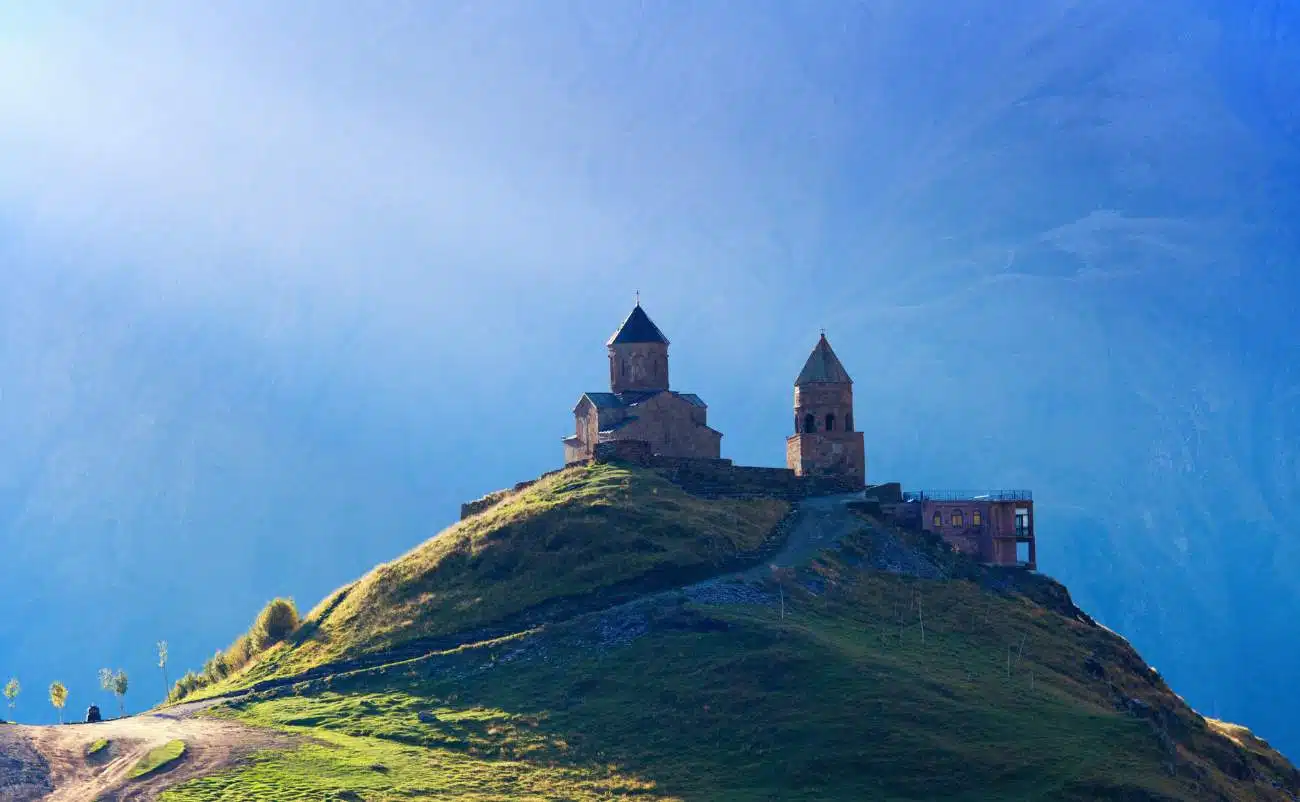 Ancient church on a grassy hilltop representing faith and spirituality, ideal for Christian worship and religious music themes.