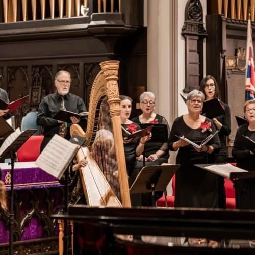 Choir performing gospel music in a church with a conductor and harp, celebrating Christian worship and hymn singing; ideal for Bible song and religious congregational music.