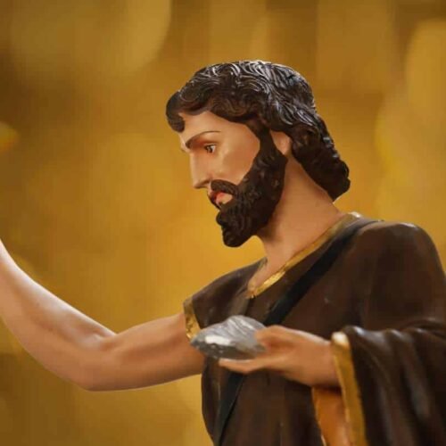 Peaceful Jesus Christ statue with golden background, symbolizing faith and devotion in Christian worship. Perfect for religious inspiration, prayer, and biblical song imagery.