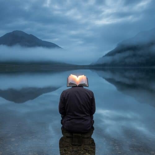 Deep Bible Verses That Inspire Reflection and Growth My Bible Song 2026 Open Bible on person's head reflecting in calm lake with mountains and misty sky, symbolizing faith and spiritual connection, perfect for Christian worship and Bible song themes.