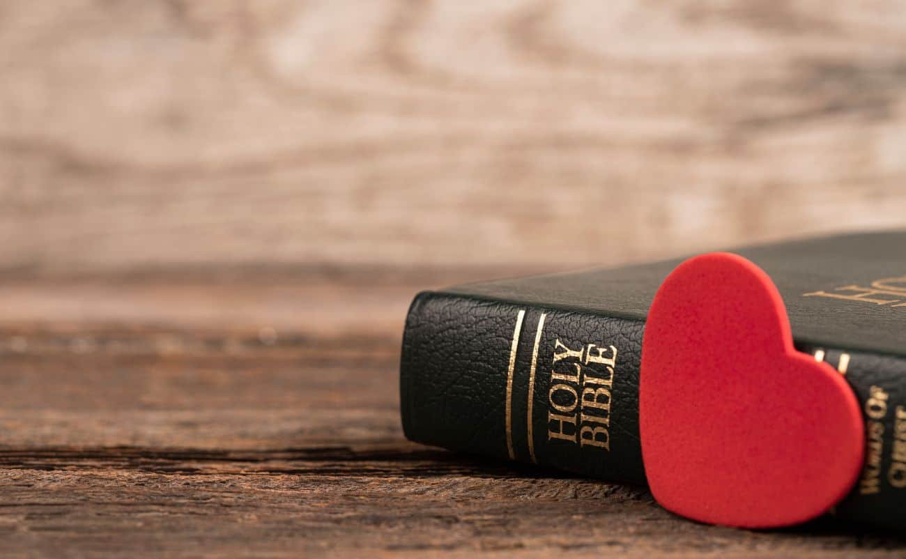 Bible with a red heart-shaped foam on top, symbolizing love for God's Word and faith.