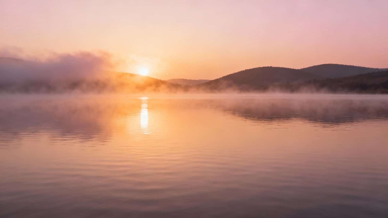 Serene sunrise over a misty lake with mountains in the background, symbolizing peace and spiritual renewal, perfect for Christian worship and Bible-based music content.