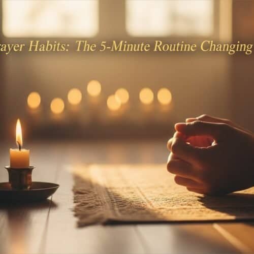 Person praying with hands clasped near a candle on a wooden table in warm, peaceful setting.