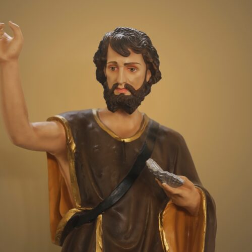 Jesus Christ statue with raised hand and Bible, religious worship figure, Christian faith symbol, spiritual leader, biblical inspiration, religious art, devotion, prayer, worship scene, faith expression, religious iconography, Christian church decor, spiritual guidance, biblical teachings, religious sculpture.