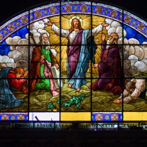 Beautiful stained glass window depicting the resurrection of Jesus Christ with vibrant colors and detailed imagery, symbolizing hope, faith, and divine salvation.